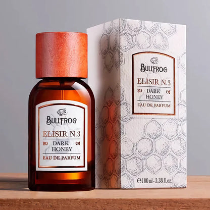 Bullfrog Elisir N.3 Dark Honey EdP flaska bredvid parfymask och honungsmönstrad design – 100 ml Eau de Parfum.